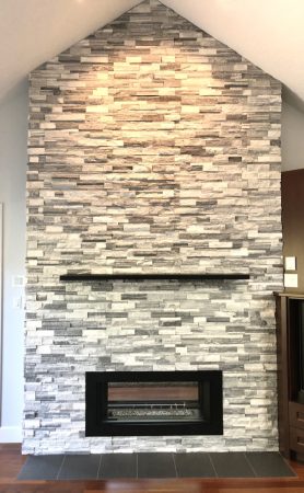 Double Sided Ledgestone Tile Fireplace with Charred Wood Mantle and See-Through Gas Insert with Heat Shift Vent Side 1 Corner Detail - Broadmead